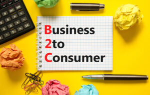 B2C business to consumer symbol. Concept words B2C business to consumer on white note on a beautiful yellow background. Black calculator and pen. Business B2C business to consumer concept. Copy space.