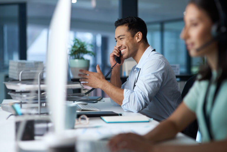 Good business is based on good communication. Shot of a young man answering the phone while working in a modern call centre.